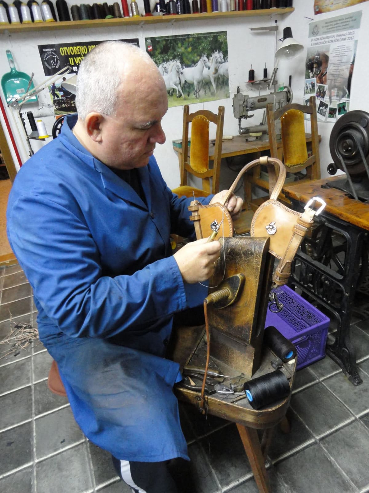 Remenar artisan at work stitching leather